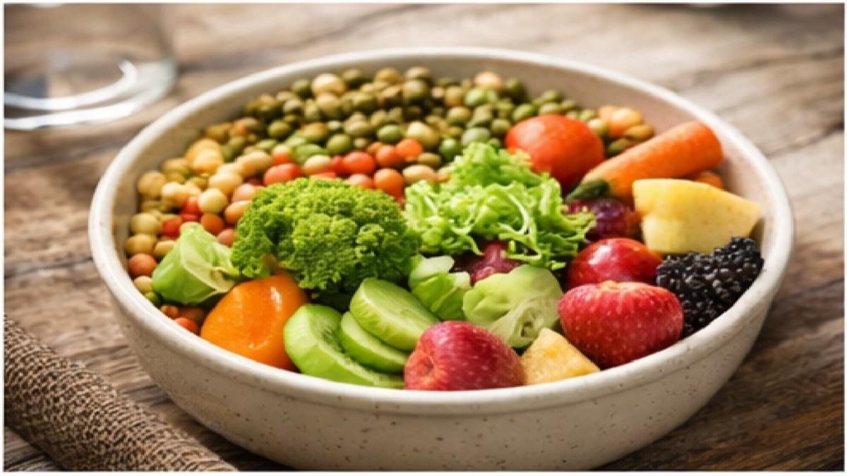 Bowl of fresh fruits, vegetables, and seeds suitable for pet birds